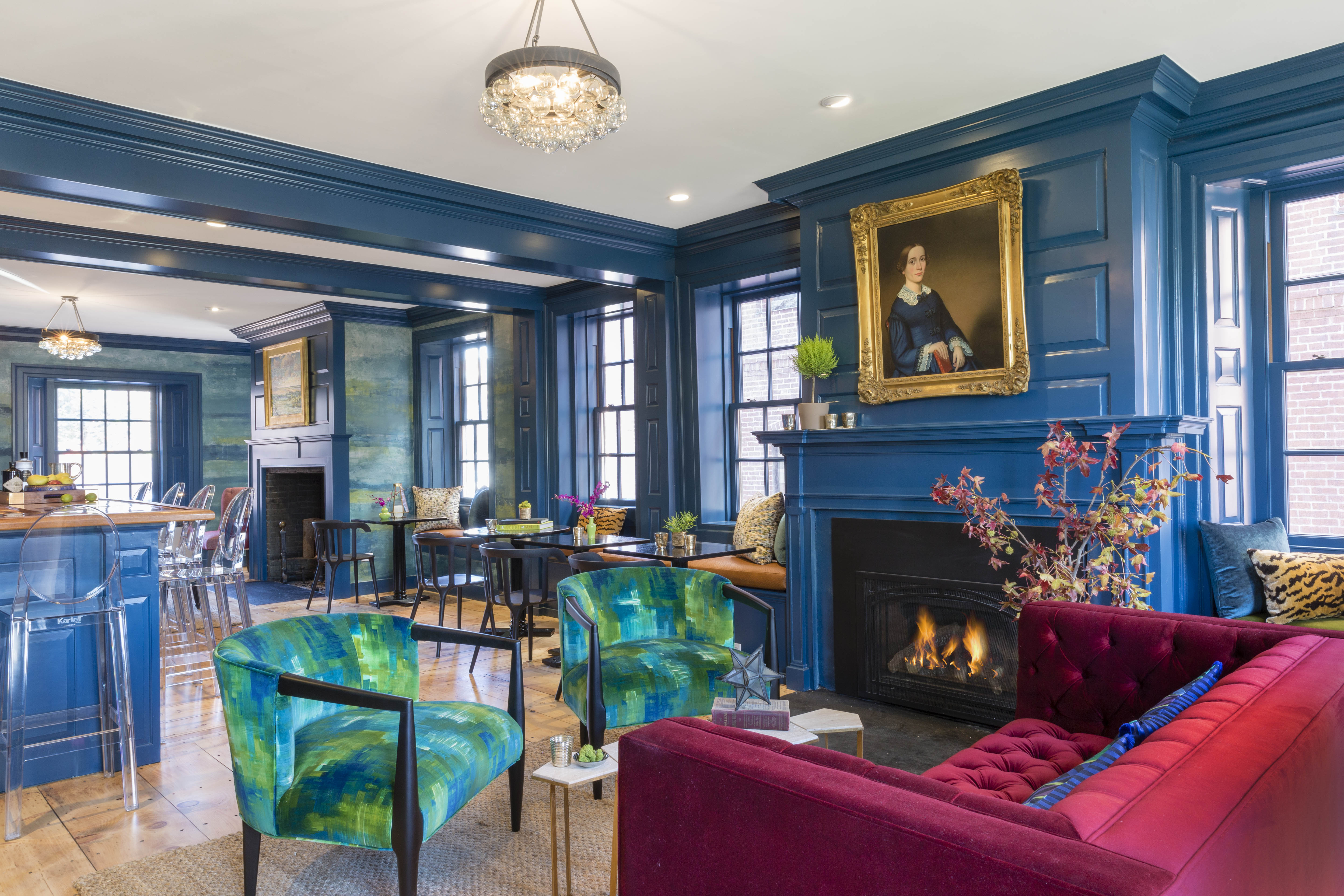 An interior of a hotel in Salem Massachusetts painted vivid blue on the walls with eclectic furniture